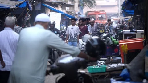 Congested Narrow lane in India with bikes, crowd of people and dingy shops Stock Footage 329098596