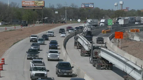 Congested traffic as huge bridge beams are hauled past, 4K. Stock Footage 151606007