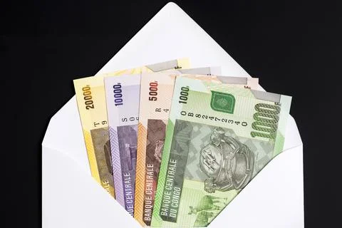 Congolese franc in a white envelope on a black background Stock Photos