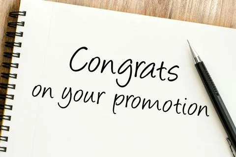 Congrats on your promotion message handwritten on a spiral notebook, symbol.. Stock Photos