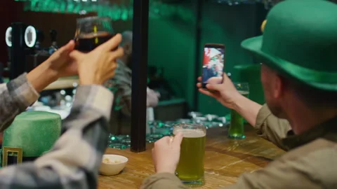 Congratulating Irish Friends on St Patricks Day via Video Call in Bar Stock Footage 261509826