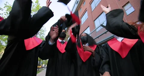 Congratulations. Low angle view of happy group of young cheerful graduates in Vidéo 155757583