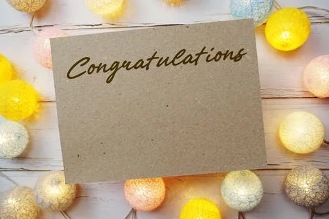 Congratulations text with LED cotton balls decorate on wooden background Stock Photos