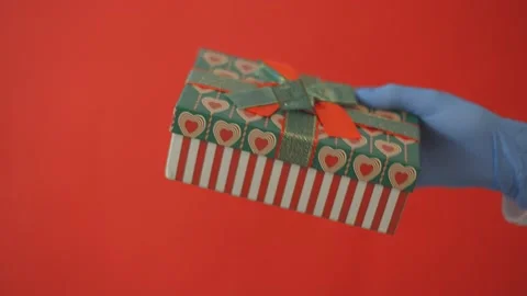 Congratulations on Valentine's Day, a hand in protective gloves  Stock Footage 146701575