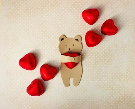 Congratulations on the Valentine's Day. A small bear of kraft paper holds in his Stock Photos