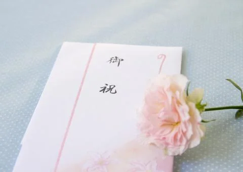 Congratulatory gift envelope and a rose Stock Photos