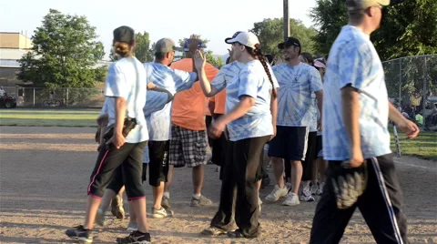 Congratulatory high 5's after small town coed softball tournament Video stock 40859109
