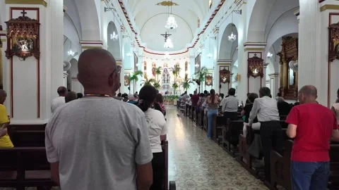 Congregation attending daytime mass service inside historic San Pedro Cathedral Stock Footage 336553831