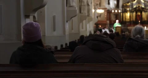 Congregation in pews during mass, priest at altar blurred. Stock Footage 320167429
