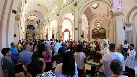 Congregation standing during religious mass inside El Palmar Cathedral in Stock Footage 336303324