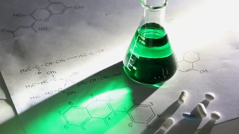 Conical flask containing green liquid on table Stock Footage 95967658