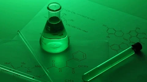 Conical flask containing green liquid on table Stock Footage 95967664