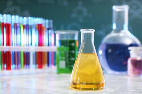 Conical flask on table against blurred background, space for text. Chemistry  写真素材