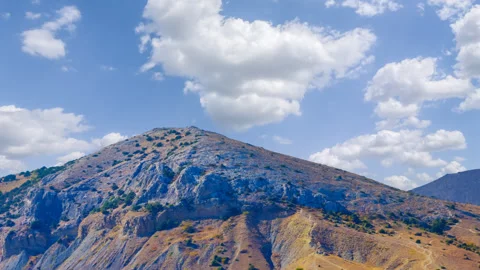 Conical mount under blue cloudy sky time lapse scene Vídeos de archivo 301083153