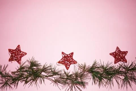 Coniferous branches and red stars - Christmas tree decorations on a New Year' Stock Photos