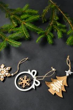 Coniferous branches on dark background top view. Wooden New Year's handmade t Stock Photos