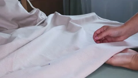 Connect the fabric with pins. Stock Footage 138141526