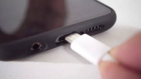 Connect USB charging cable to smartphone - Macro Stock Footage 119607903