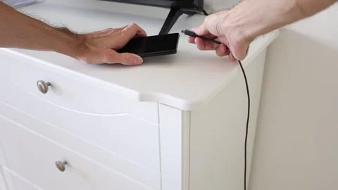 Connect wire plug into smartphone for charge Stock Footage 310859531