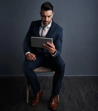 The connected exec is a productive exec. Studio shot of a stylish young Stock Photos