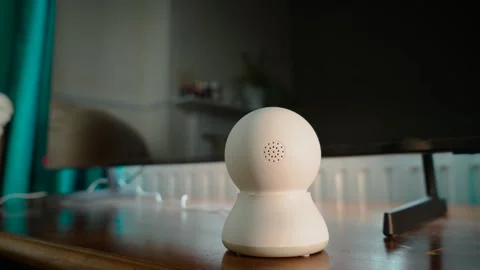Connected home security camera near television for indoor remote surveillance Stock Footage 336309676