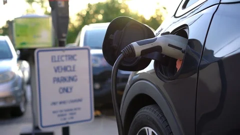 Connected plugged electric vehicle EV at dedicated parking charging Stock Footage 107627611