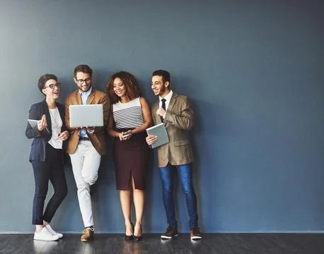 The connected team is an efficient team. Studio shot of a group of Stock Photos