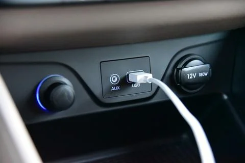 Connected USB cable into the USB port on the car dashboard Stock Photos