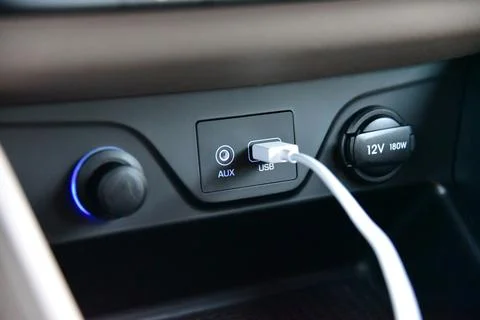 Connected USB cable into the USB port on the car dashboard Stock Photos