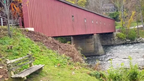 Connecticut’s scenic red Covered Bridge at New England changing autumn leaves Stock Footage 166175145