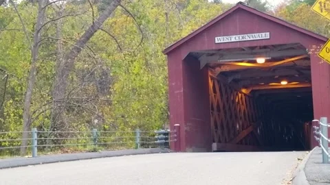 Connecticut’s scenic red Covered Bridge at New England changing autumn leaves Stock Footage 166175531
