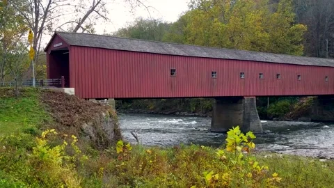 Connecticut’s scenic red Covered Bridge at New England changing autumn leaves Stock Footage 166176031