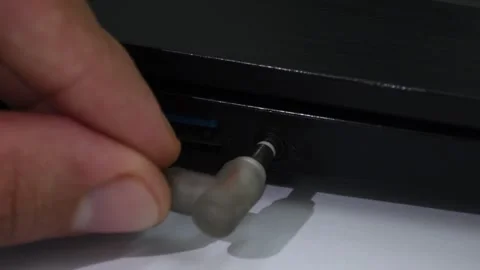 Connecting 3.5mm audio plug to laptop or PC, inserting headphones or earphones Stock Footage 305778133