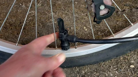 Connecting an air pump and Inflating a bike tyre / tire. Stock-Footage 130386428