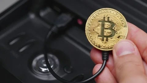 Connecting BTC to your computer. Activating a bitcoin coin by connecting a .. Stock Footage 251043316