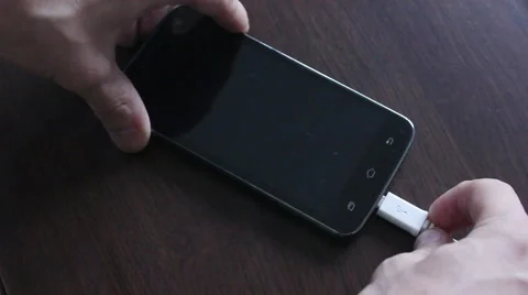 Connecting cable at smarphone Stock Footage 55532328