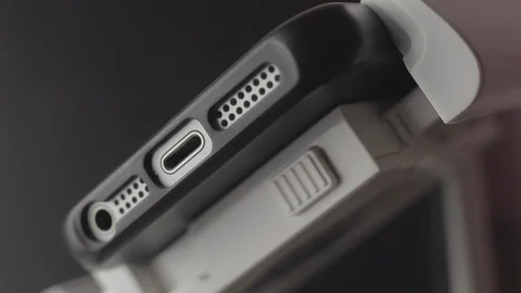 Connecting cable to smartphone. Preparing a drone before flight. Close up Stockbeeldmateriaal 128630933