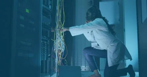 Connecting cables network tech using headset in server room with toolbox, copy Stock Photos