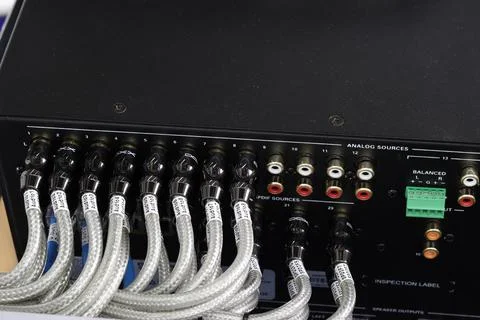 Connecting a coaxial audio wire using RCA connectors to a sound amplifier. Stock Photos