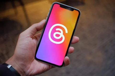 Connecting Devices: Smartphone Showing Threads App Logo Stock Photos