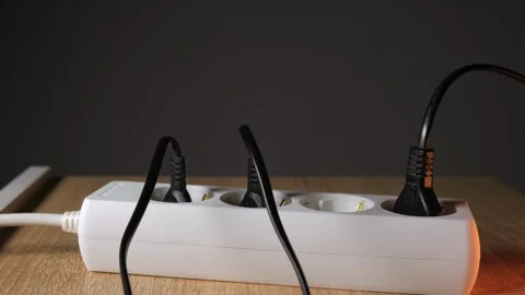 Connecting electrical equipment to an outlet, charging a phone Stock Footage 265013908
