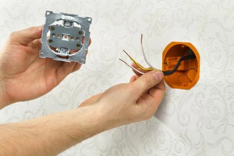 Connecting an electrical outlet to the mains Stock Photos