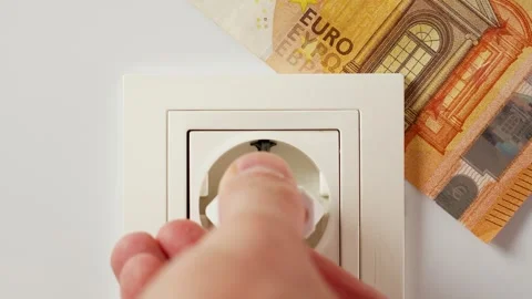 Connecting an electrical plug adapter to a household socket with a euro banknote Stock Footage 248380120