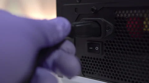Connecting an electrical plug to the power supply unit of a personal computer Stock Footage 151911302