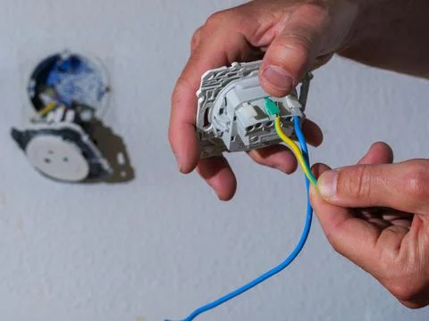 Connecting electrical wires to wall socket installation Stock Photos