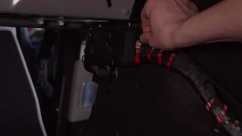 Connecting the Electrical Wiring Harness within the Interior of a Vehicle for Stock Footage 311367693