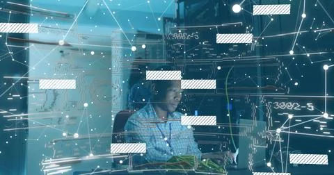 Connecting ethernet cables tech wearing checkered shirt monitoring network on Stock Photos