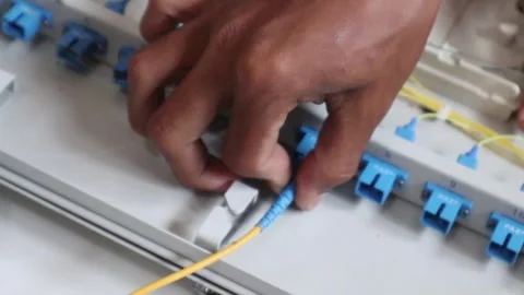 Connecting the fiber optic cable to the internet network port Stock Footage 343328643