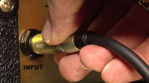 Connecting a guitar cable to the amplifier Stock Footage 51033225