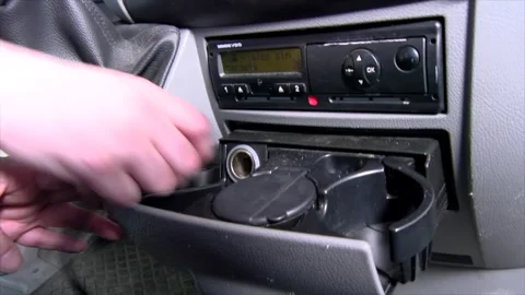 Connecting a handheld car vacuum cleaner to the car cigarette lighter Stock Footage 279176430